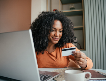 amazon debit card payment woman holding card on laptop